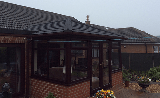 A brown conservatory on a bungalow